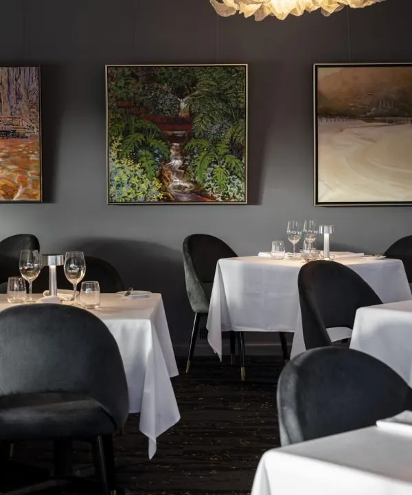 Lake House Restaurant, where dark walls and original artwork set the scene for 2 Chef's Hats dining