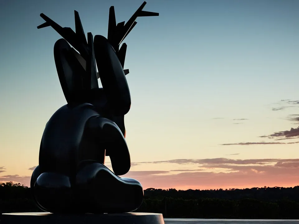 The Jackalope sculpture silhouetted against a Peninsula sunset