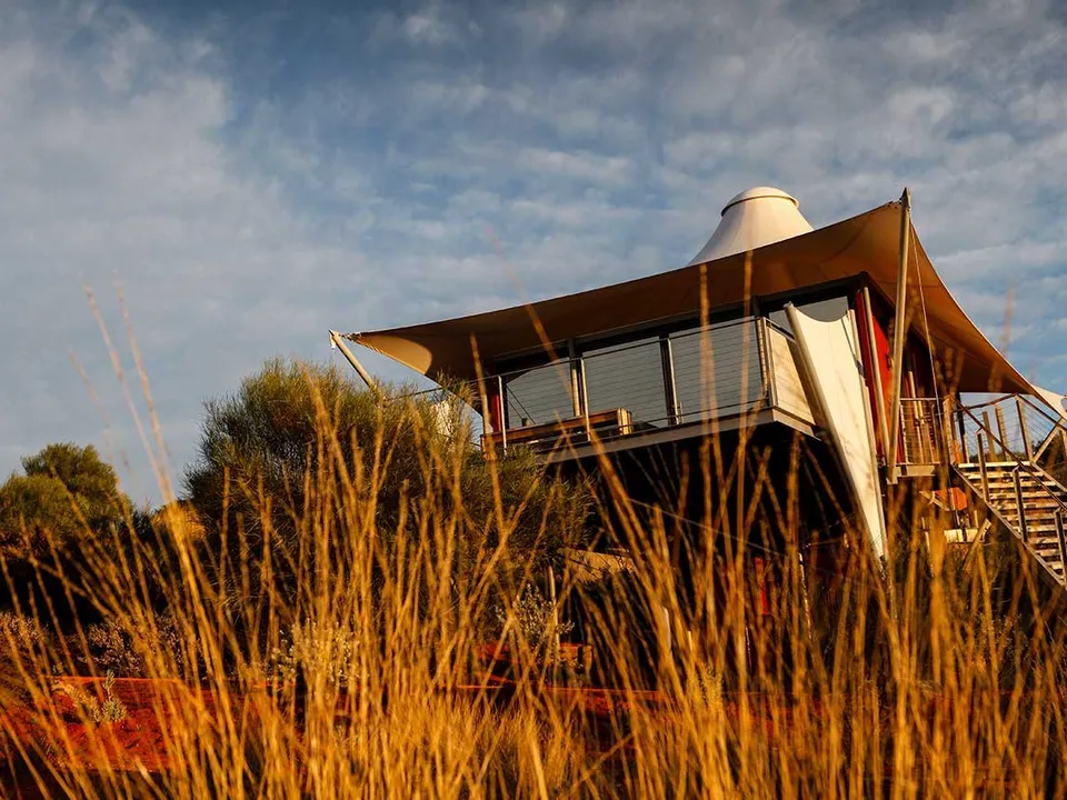 Luxury tent pavilion framed by native desert grasses