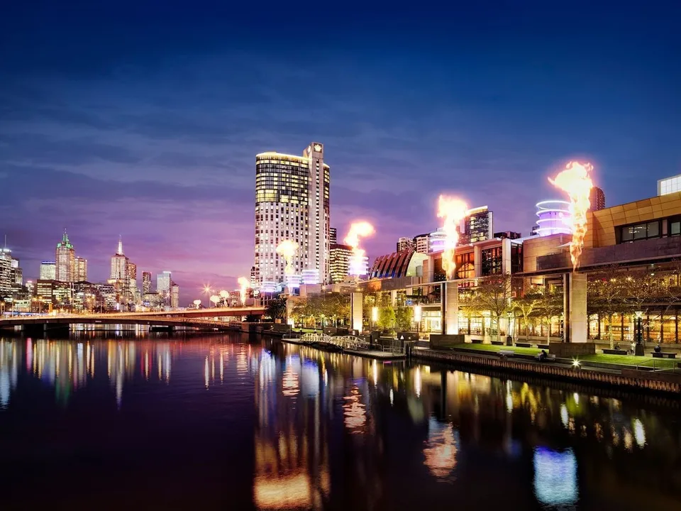 Crown Melbourne and the Yarra River at twilight, with the iconic fire towers lighting up the Southbank skyline