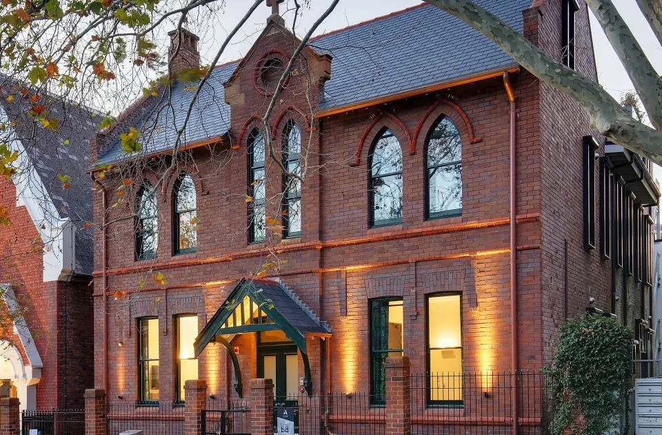 The restored 1903 convent facade at dusk on Little Albion Street