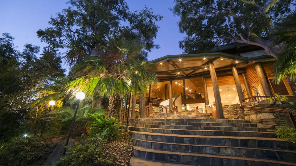The timber lobby entrance surrounded by native gardens