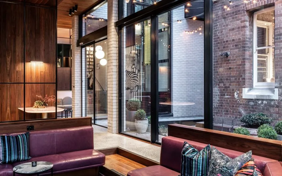 The sunken lounge with courtyard views and festoon lights