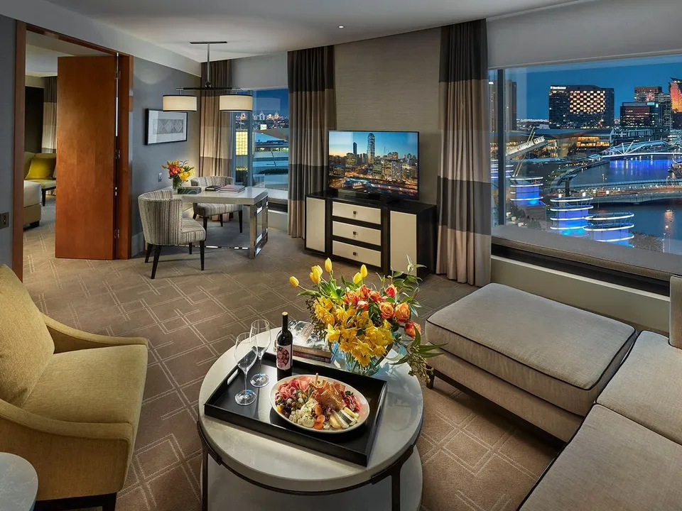 Executive Suite living area with floor-to-ceiling windows and Yarra River panorama