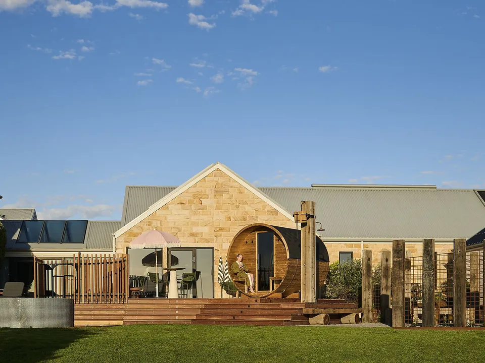 The sandstone spa building with barrel sauna and outdoor contrast therapy area