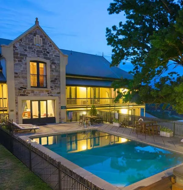 Heritage manor and pool at dusk