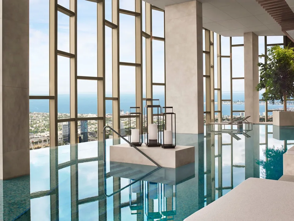 The indoor infinity pool on level 64 with sweeping views to Port Phillip Bay