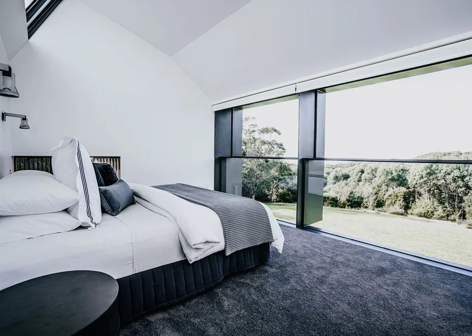 Bedroom with floor-to-ceiling windows and Otways bush views