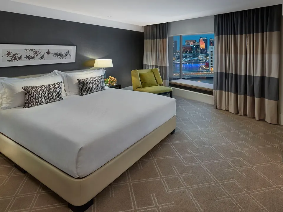 Executive Suite bedroom with panoramic Melbourne city and river views